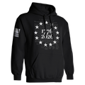 1776 2026 patriotic black hoodie with Betsy Ross 13 star circle and We The People Constitution script background.