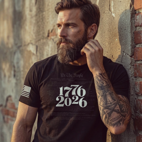Man wearing a black t-shirt with '1776 2026' text against a textured wall.